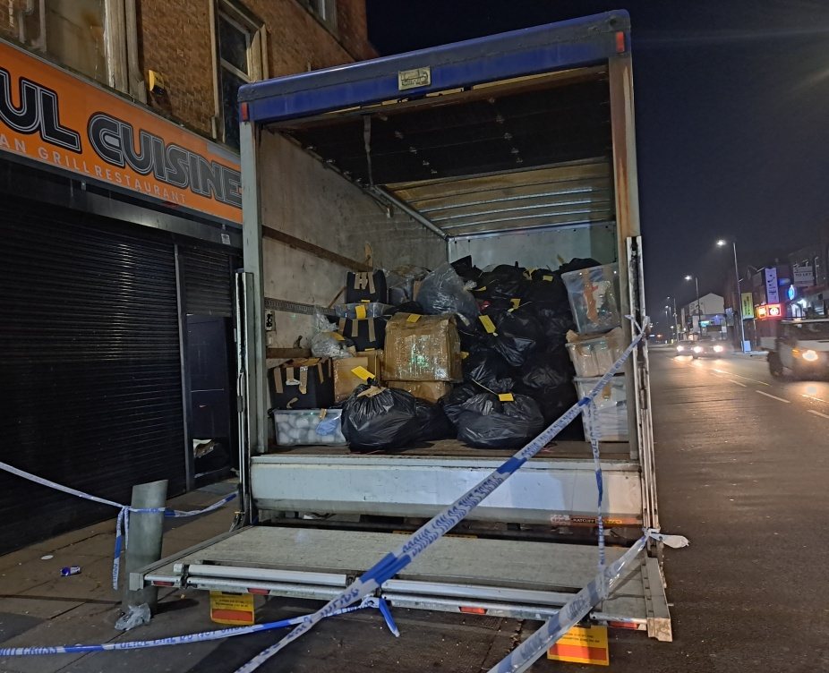 The back of a truck loaded with confiscated counterfeit stock, taped off during Operation Vulcan