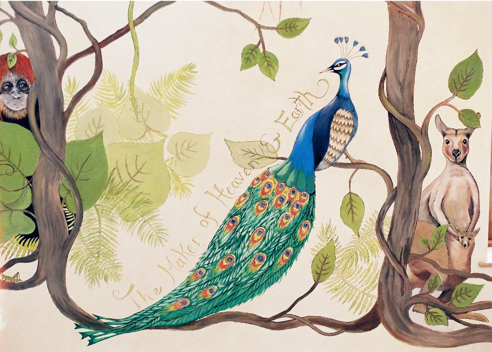 Hand-painted jungle mural of a peacock perched on a vine-wrapped branch between an orangutan and a kangaroo with her joey, with the hand-lettered words The Maker of Heaven and Earth curving around the peacock's tail