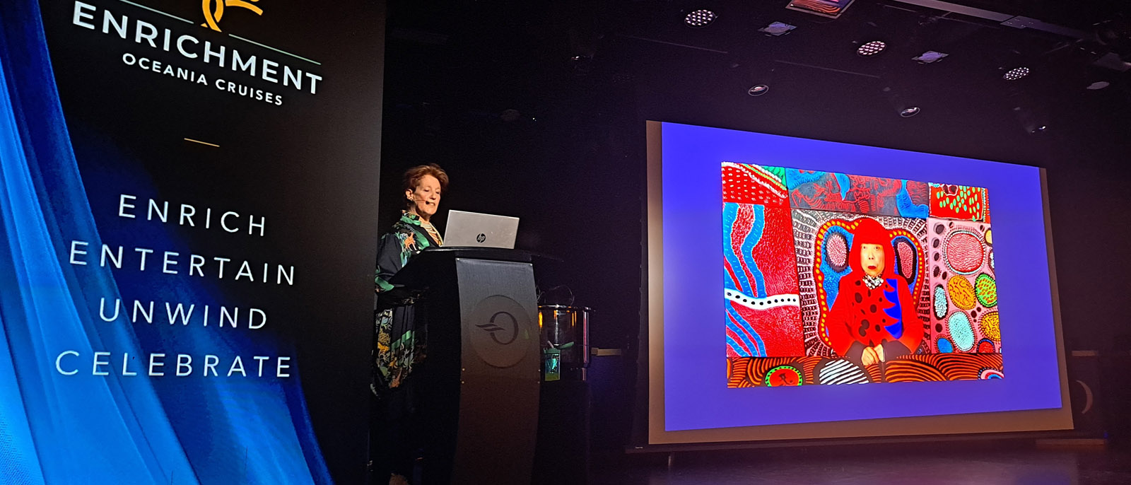 A brightly patterned polka-dot self-portrait artwork shown on screen during Louise Garman's talk